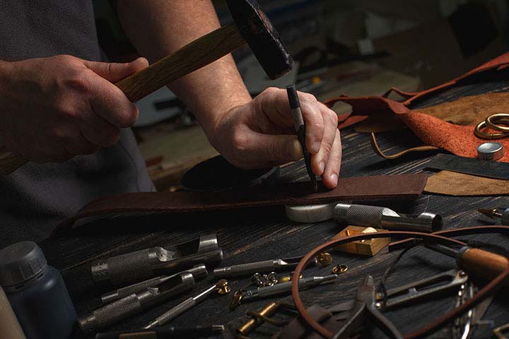 Why Rely on Centuries-Old Techniques for Modern Leatherwork?; Man working with leather using crafting DIY tools